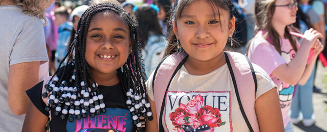 First day of school photo 2024. Two elementary students getting ready to go into the school.