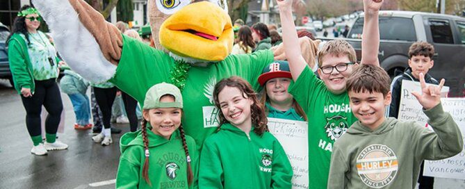 Hough parade Hawk mascot and students